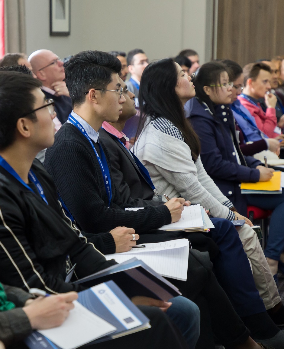 Cropped shot of group of people in a lecture hall, watching attentively