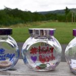 Row of glass jars containing buttons