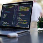 Laptop with code on a desk