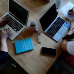 Two women working with laptops