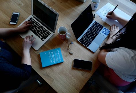 Two women working with laptops