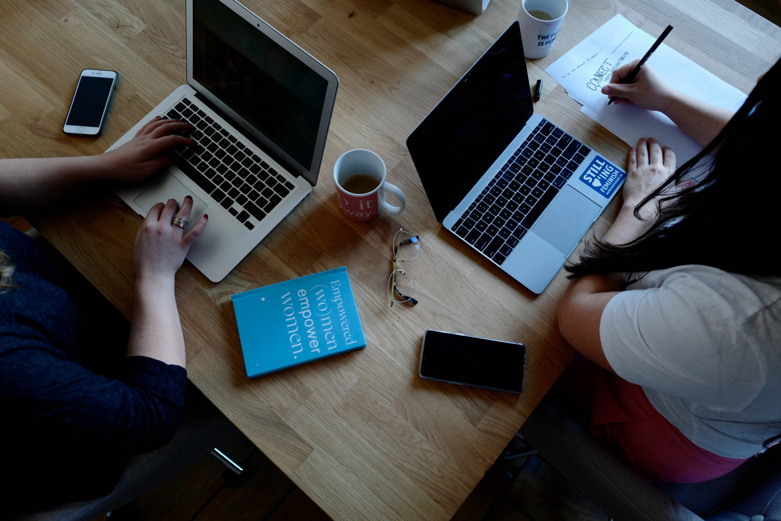 Two women working with laptops
